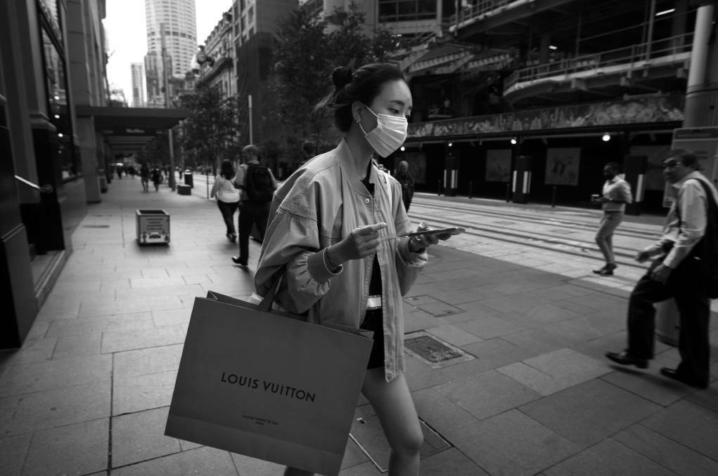 Only 'essential' stores were allowed to remain open for trade. Shoppers on George Street, Sydney, March 23, 2020. Photo: Dean Sewell/Oculi
