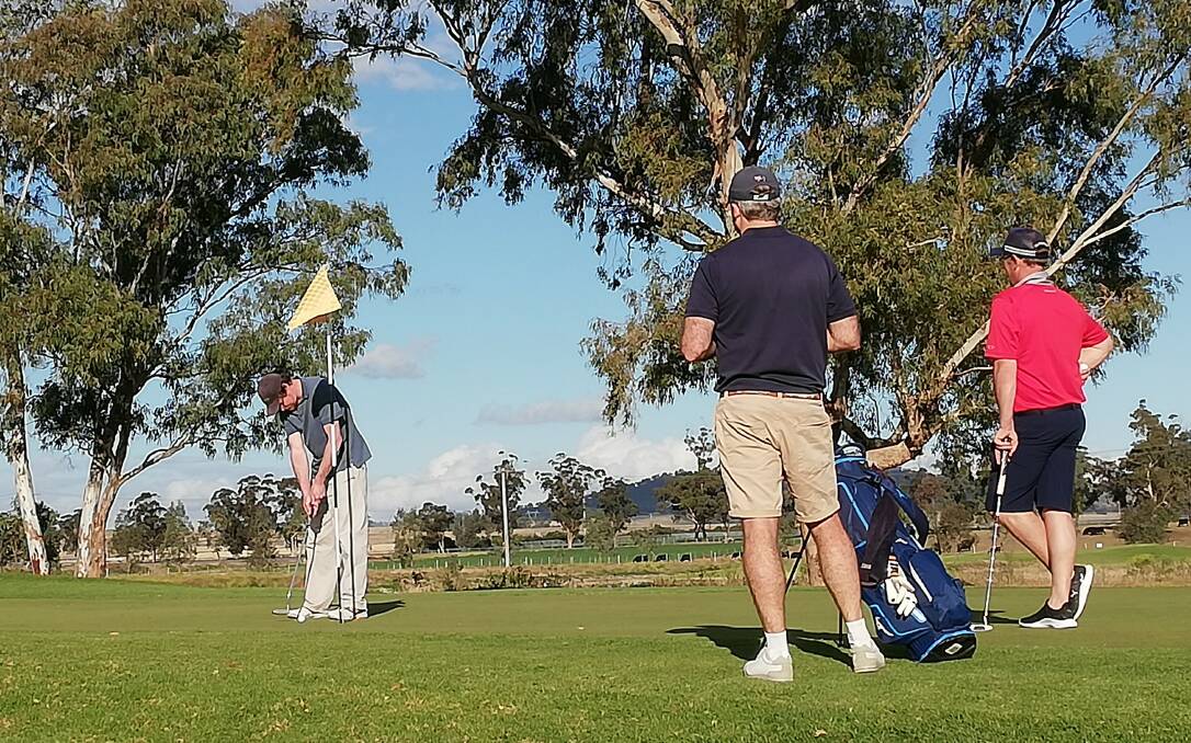 Matt Langan birdies the 11th, in front of Duncan Yuille and Stuart Sheldrake, at Scone Golf Club on June 27