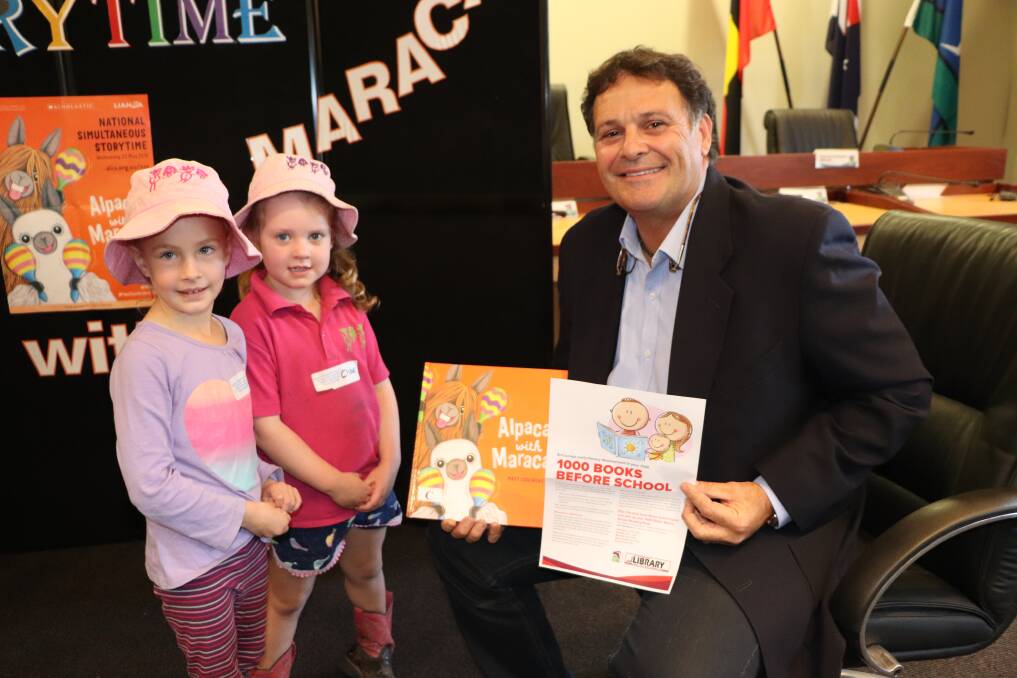 BOOK WORMS: Launching the 1000 Books Before School program, after National Simultaneous Storytime in Scone this week, were Upper Hunter Shire mayor Wayne Bedggood and Scone Pre-Schoolers Chloe and Georgie.