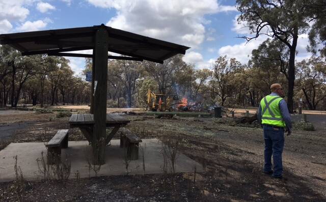 DEVASTATION: Upper Hunter Shire Council deputy mayor Maurice Collison inspects the extensive damage to the Cassilis Park Rest Area on Wednesday as clean up operations begin.