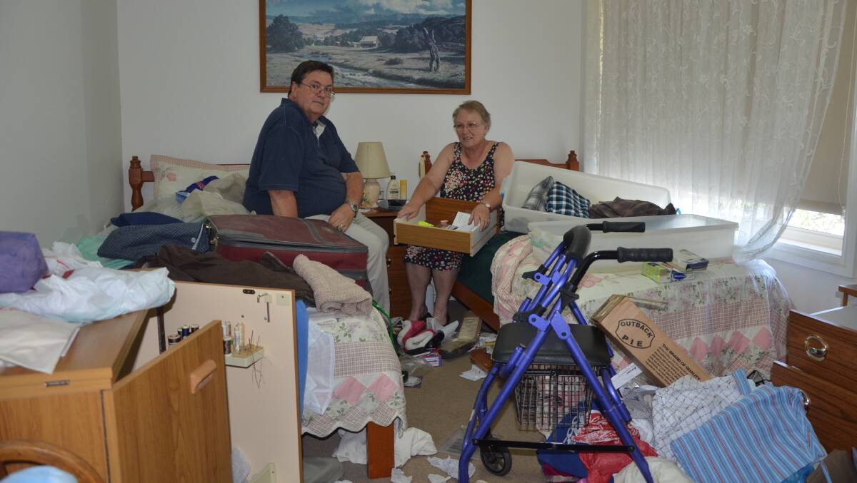 DEVASTATED: Neville and Christine Moxon survey the damage at Mrs Moxon's parents' home in Scone after thieves ransacked the place.