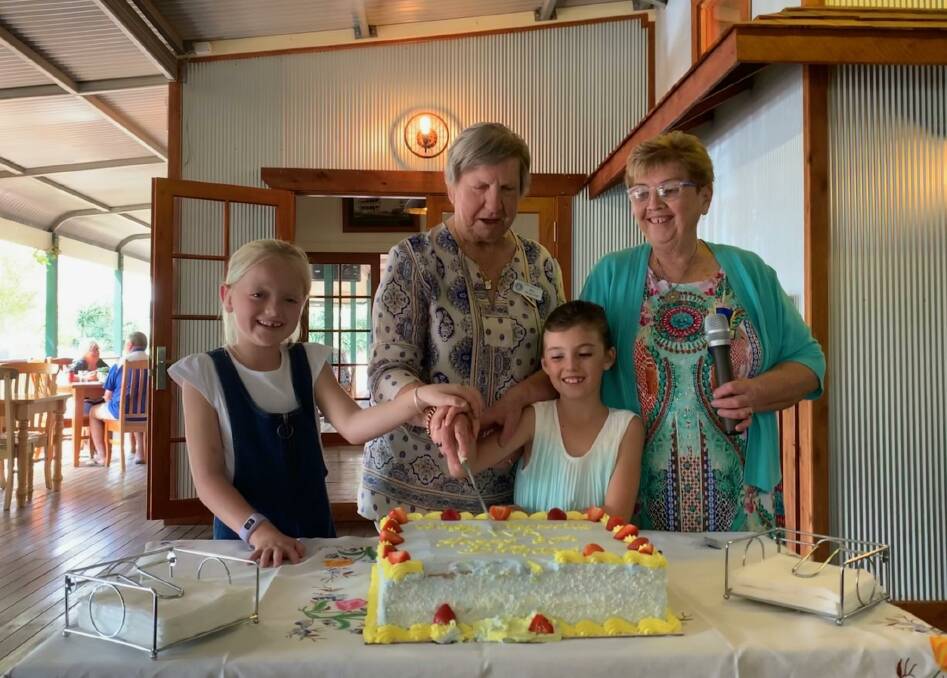 HAPPY BIRTHDAY: Wingen Parkville CWA vice president and oldest member Del Mayled cuts the cake with youngest members Faith and Ella and president Helen Gardner.