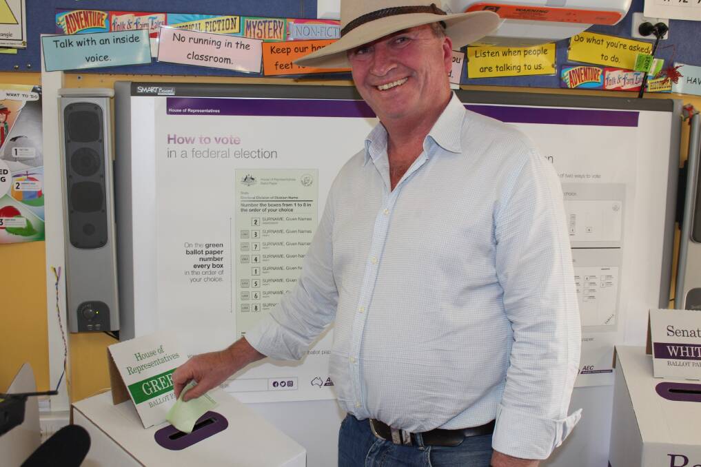 CASTING VOTE: New England MP Barnaby Joyce casts his vote at his home town booth at Woolbrook Public School.