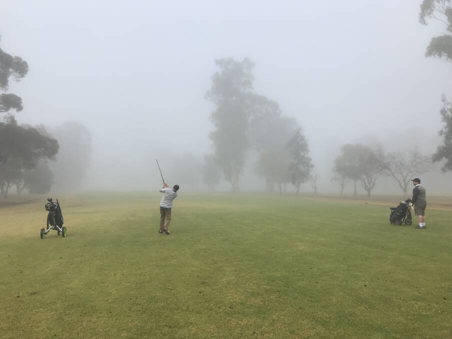 Danny Malone and Scott Collins watching their balls disappearing into a foggy Saturday morning. 