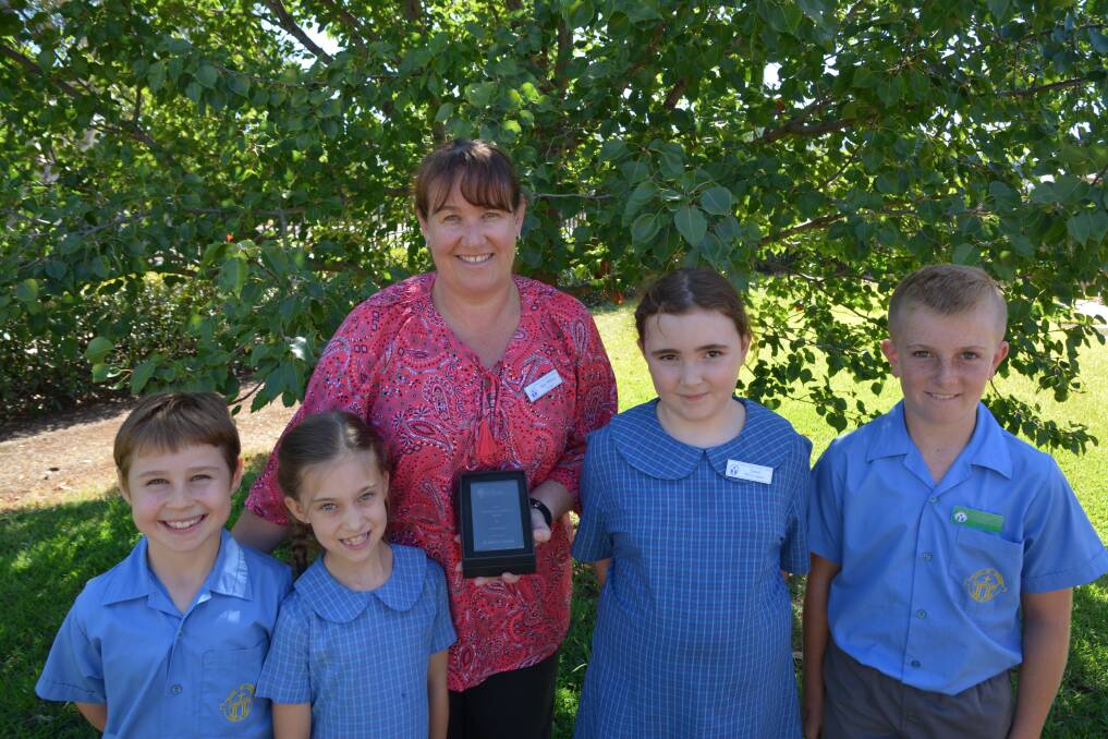 PROUD: St Mary's Primary School students Benjamin Highland, Emelia Keep, Cecilia Cooper and Sam Carr with principal Kim Wilson holding the Monsignor Coolahan Award for Community.