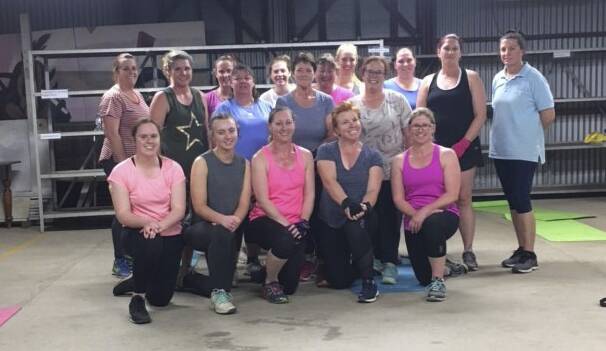 CHALLENGE: Emma Evans with her Monday night group fitness class 'Em's Group Fitness' at the Merriwa Showground. Photo: Supplied