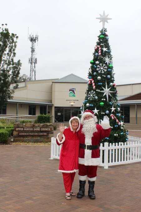 FESTIVE SPIRIT: Mrs Claus - Cr Lee Watts and Santa with the first of four Christmas trees for the Upper Hunter.
