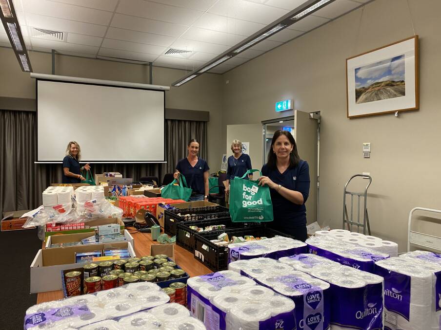 LENDING A HAND: Upper Hunter Shire Council staff volunteering to pack groceries. Photo: Supplied 