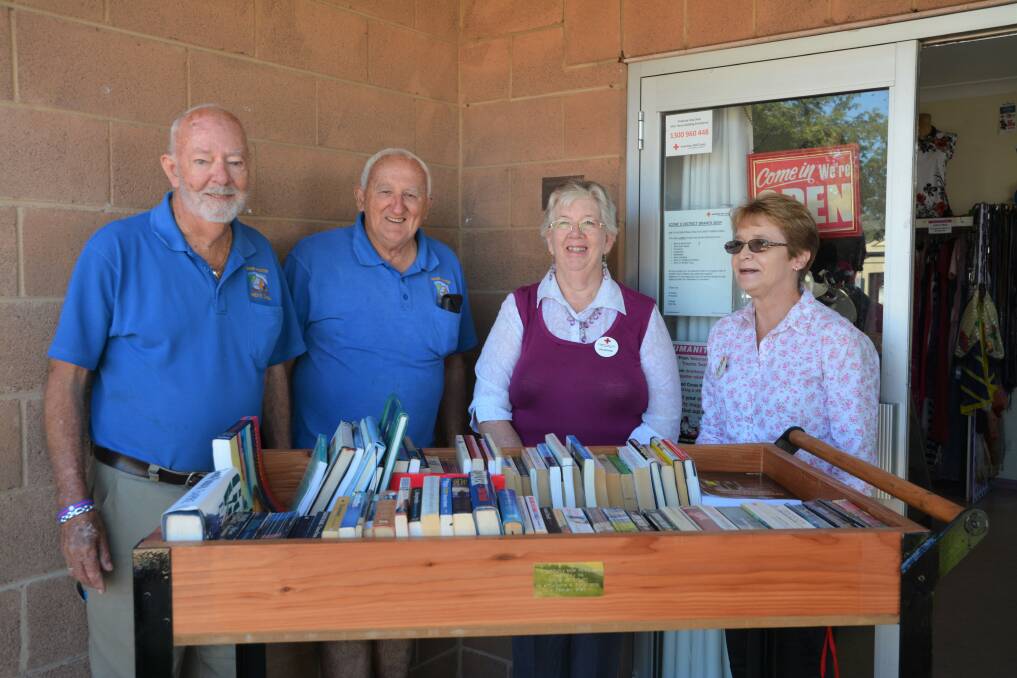 GRAB A BOOK: Upper Hunter Men's Shed members George Clementson and David Spencer with Scone Red Cross volunteer Annette Ashford and liaison officer Jill Hush. 