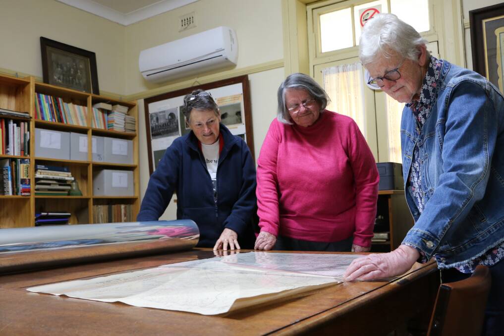 Scone and Upper Hunter Historical Society members Carolyn Carter (president), Sandra Graham and Dianne Walmsley encapsulate historical maps with funds from Council's CAG. 