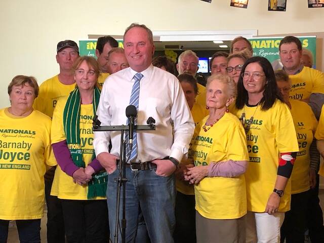 TRIUMPH: Barnaby Joyce claims victory at the Tamworth Tennis Club surrounded by National party supporters on Saturday night. 
