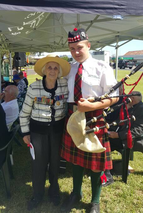 PAYING RESPECTS: June Healy and Scone RSL Pipes and Drums member Harry Brown at the Scone Remembrance Day ceremony on Saturday.