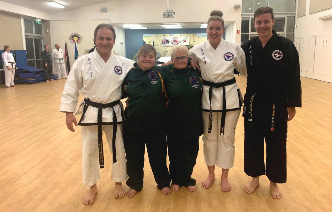 KICKING GOALS: Toogee Martial Arts assistant instructors Samm and Paul Turri and Josh Quinn with Cassie Fisher and Jill Hamling in their new uniforms ready for the International Special Needs Taekwon-Do Games. 