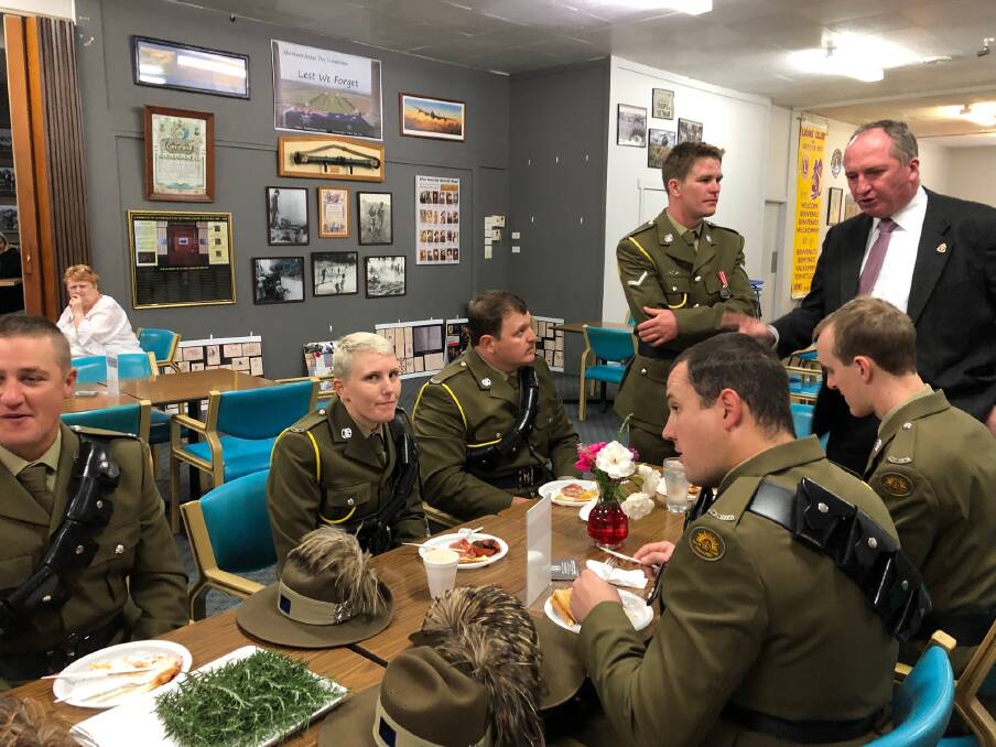 New England MP Barnaby Joyce chatting with army reserve members during breakfast at the Aberdeen Anzac Day dawn service.