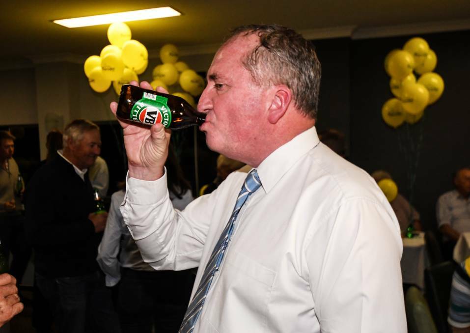 CHEERING: Barnaby Joyce enjoys a drink after declaring victory in New England for a third term. Photo: Gareth Gardner/Northern Daily Leader 