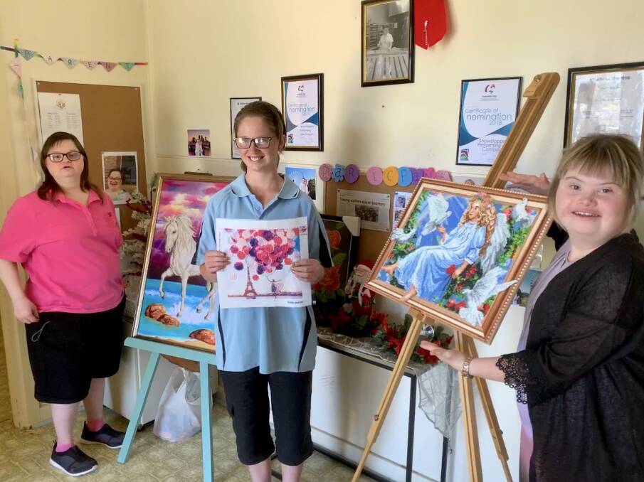 CREATIVITY: Lizzie, Cassie and Gypsy with some of their creative works at the Showstoppers Ability Services Scone Open Day on Tuesday. Photo: Patricia Taylor 