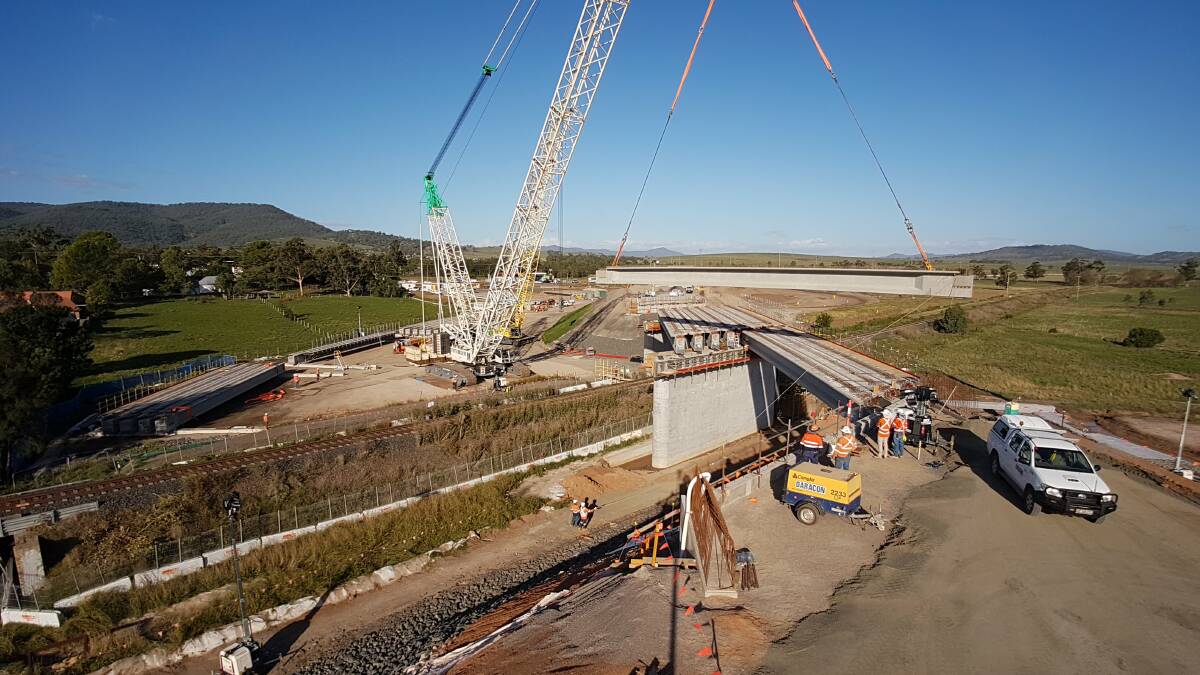 CRANES IN THE SKY: More than 20 concrete girders were put in to create a bridge over the railway line on the southern side of Scone. Photo: RMS