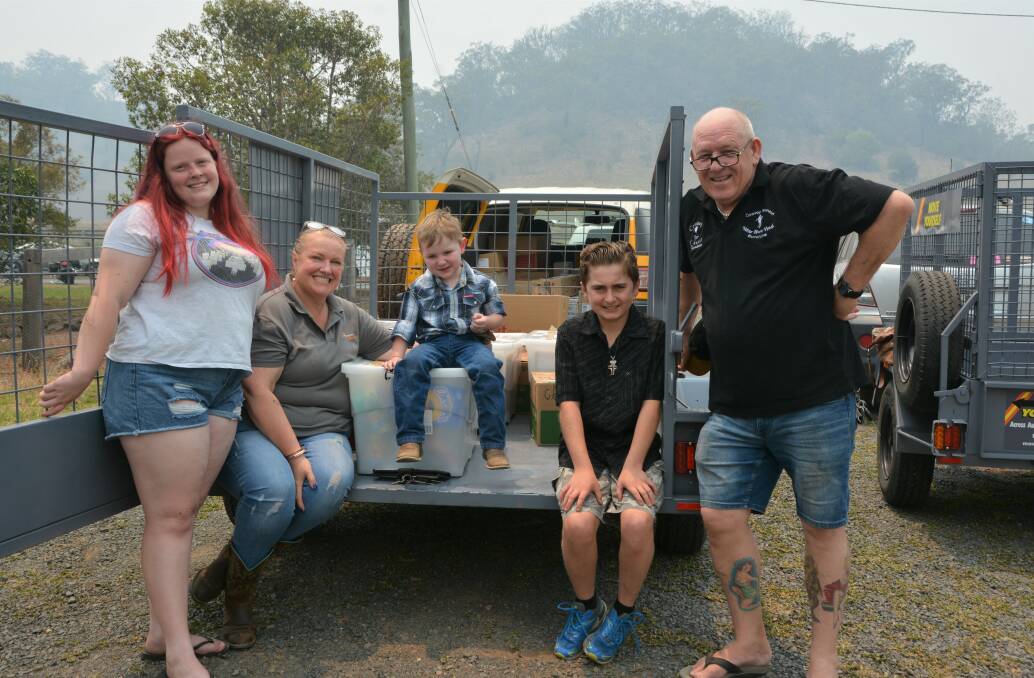 HELP ON HAND: Caitlin, Gretchen, Peter and Finch with the young Murrurundi boy who touched their hearts and inspired them to lend a hand, Coby (centre) stop for a break at the Wingen Hotel on Sunday.