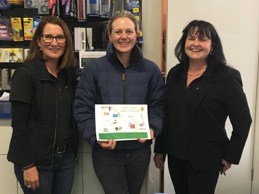 ​HIDDEN TREASURES: Scone Chamber Executive Officer Claire Quigley with representatives of Scone Newsagency who is involved in the promotion.