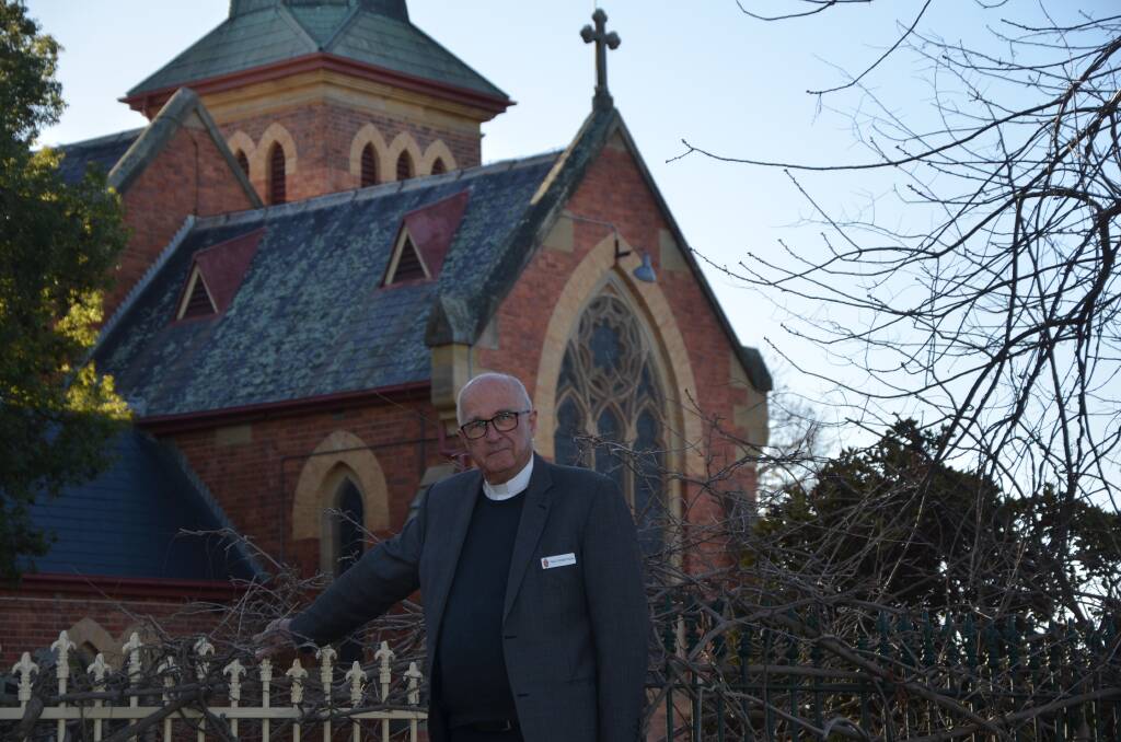 Father Paul Robertson in front of Scone Anglican Church