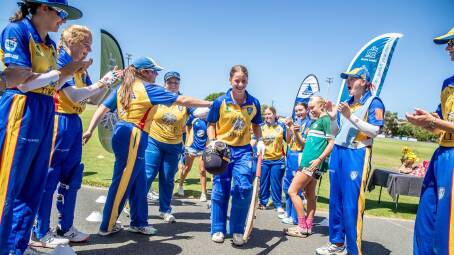 Caoimhe Bray is clapped off Townson Oval by Greater Hunter Coast teammates after hitting 202 in the Brewer Shield grand final on Sunday. Picture by Andrew McCrae