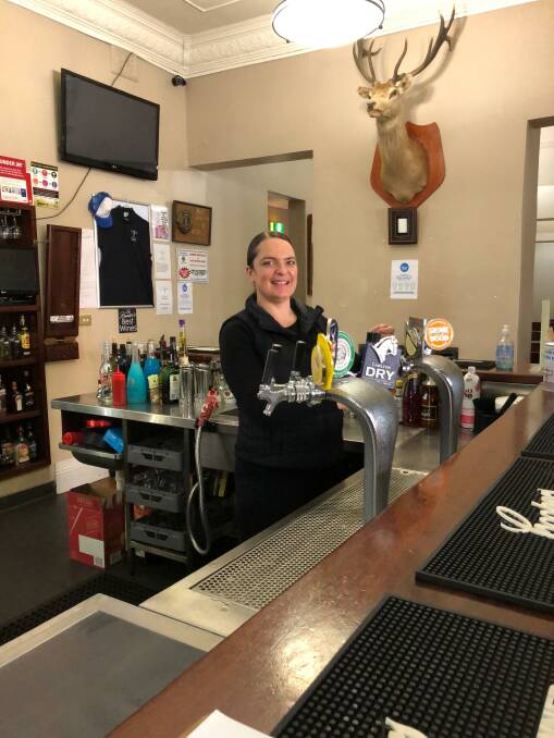 White Hart Hotel owner Kylie Arnold-Cross pours a beer. Photo: supplied