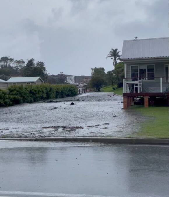 A private dam on a development site at Catherine Hill Bay has overflowed in Saturday's heavy rain. Picture supplied.