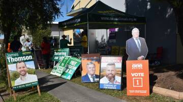DEMOCRACY: The footpath outside the pre-polling centre in Singleton (Youth Venue on the corner Pitt and Bathurst streets) is festooned with candidates corflutes as volunteers handout how-to-vote flyers. 