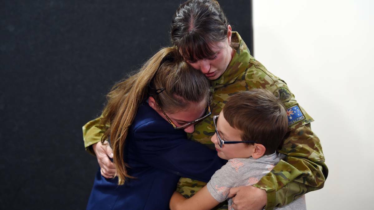Allee and Brody Butler-Yorston with their parent and aunt Army reservist Corporal Marie Yorston reunited after she had been deployed for a month in Operation Bushfire Assist. Picture: Kate Healy