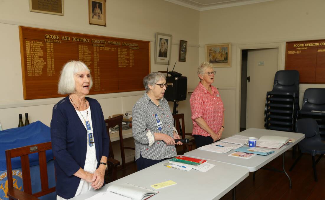 TRADITION: Scone and District CWA members Sue Lewis (treasurer), president Lyn Tout and secretary Carolyn Carter sing the national anthem.