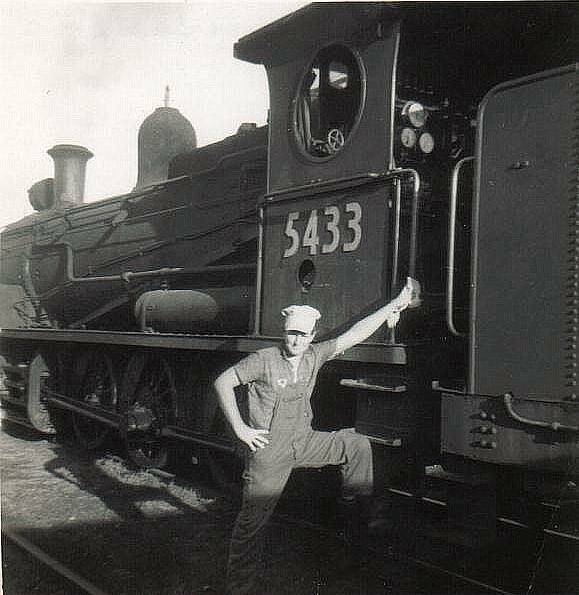 Ray Cross, as a young rail worker, with a steam locomotive. Picture: Courtesy, Ray Cross 