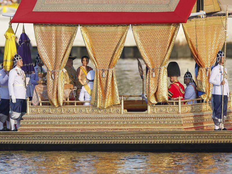 Thailand's king, queen and their son boarded a century-old barge for the procession in Bangkok.