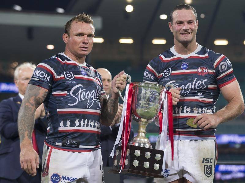 Jake Friend (L) holds the Anzac Day Cup after the Sydney Roosters' NRL defeat of St George Illawarra