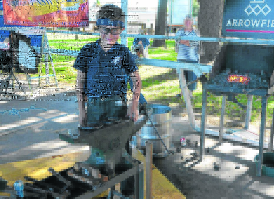 Eight-year-old Campbell Hinze creating history being the youngest ever competitor in the Professional Farriers Association NSW Branch State Title Farrier and Blacksmith Competition at White Park on the weekend. 