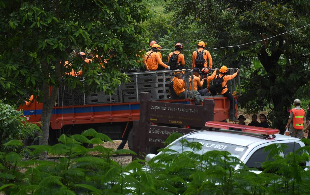 Thai rescue volunteers make their way up to the base camp near Tham Luang cave.Picture: Kate Geraghty
