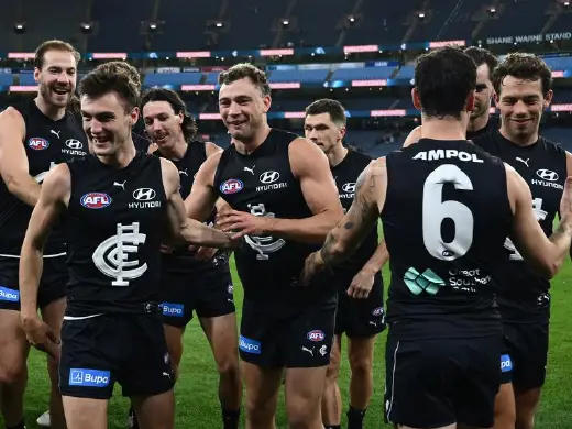 Carlton Blues players celebrate a victorious end to a difficult week with their win over the Tigers. Photo: Joel Carrett/AAP PHOTOS