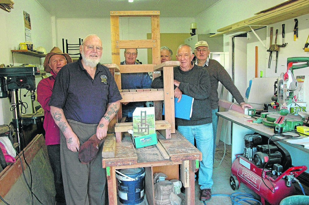Murrurundi Community Men’s Shed members (front, left to right) Ray Millar, Kevin Taylor, Ralph Stockdale, Neville Clark, Ray Shoobert and Phillip Dunn with the story book chair they are currently building for Murrurundi Public School. 